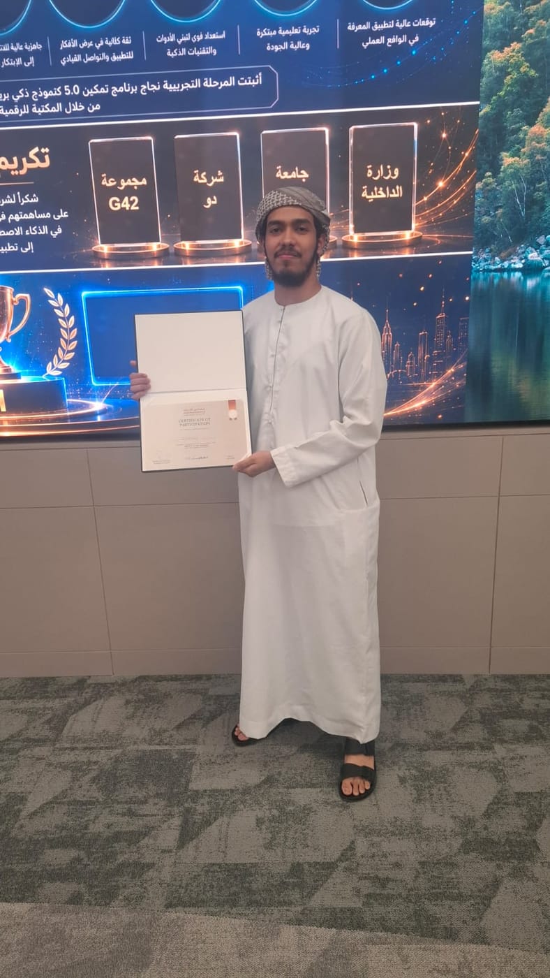 A certificate of participation held open in front of a Tamkeen 5.0 screen listing contributing organisations.